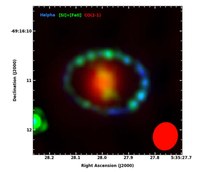 A color composite image of SN 1987A. The unresolved 12CO 2-1 line emission detected by ALMA (red). The red ellipse at lower is the synthesized beam. Note also the H emission (blue), and the [Si I] + [Fe II] 1.644 micron emission (green in the ring; yellow in the ejecta) observed with HST (Larsson et al. 2013).