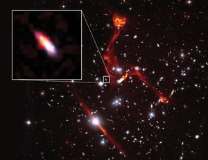 The Hubble Frontier Field MACSJ0717+3745. RGB image: HST F814W, F606W, F435W. Inferno color scale: VLA 3GHz.  The inset image shows a lensed galaxy at z=1.1, which is one of the faintest radio-emitting object ever detected. Credits: Ian Heywood, Sophia Dagnello. 